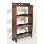 An early 20th Century oak Arts and Crafts open bookcase of smaller proportions, four fixed shelves