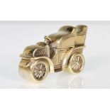 A brass vesta case in the form of a vintage car having a hinged lid to the back. Measures 4.5cm.