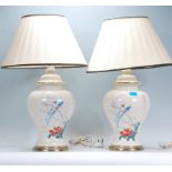 A pair of 20th century Chinese famille rose porcelain table lamps of baluster form, decorated with