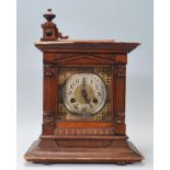 A 19th century Victorian oak cased mantel clock having a silvered and brass dial with inset brass