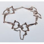 A silver hallmarked ladies stirrup link bracelet with safety chain. Hallmarked London 1974. Bracelet