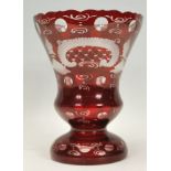 A 20th Century ruby glass vase of tapering knopped form raised on a round footed base, having