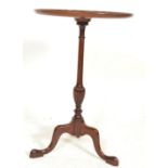 A 19th Century mahogany wine table having a central knopped column raised on a tripod base, the