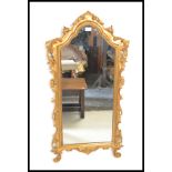 A 19th Century giltwood Rococo style wall mirror of arch form, having gilt detailing with C scroll
