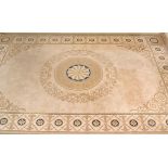 A large 20th century Axminster rug in beige ground with geometric decorated central field having