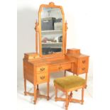 A 20th Century contemporary light oak Cotswold style dressing table, drop centre mirror raised on