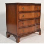A 20th century antique style mahogany serpentine fronted bachelors chest of drawers. Raised on