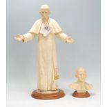 A 20th Century Capodimonte tall figurine depicting Pope John Paul II waving, raised on a round