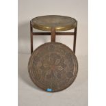 A 20th century brass charger folding Binaries occasional table. The brass tray of circular form