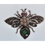 A stamped 925 silver bug brooch in the form of an insect with outstretched wings set with