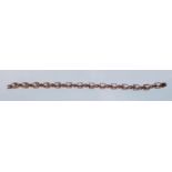 A 9ct gold hallmarked morganite set line bracelet, set with fourteen cut morganite cut stones having