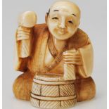 A believed 19th century Chinese carved netsuke in the form of a carpenter with hammer and drum being