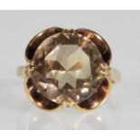 A hallmarked 9ct yellow gold ring having a decorative scroll mount set with a large central round