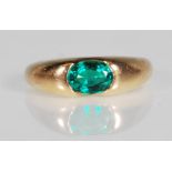 A 9ct gold and green stone ring. The ring being set with an oval cut emerald green gemstone.