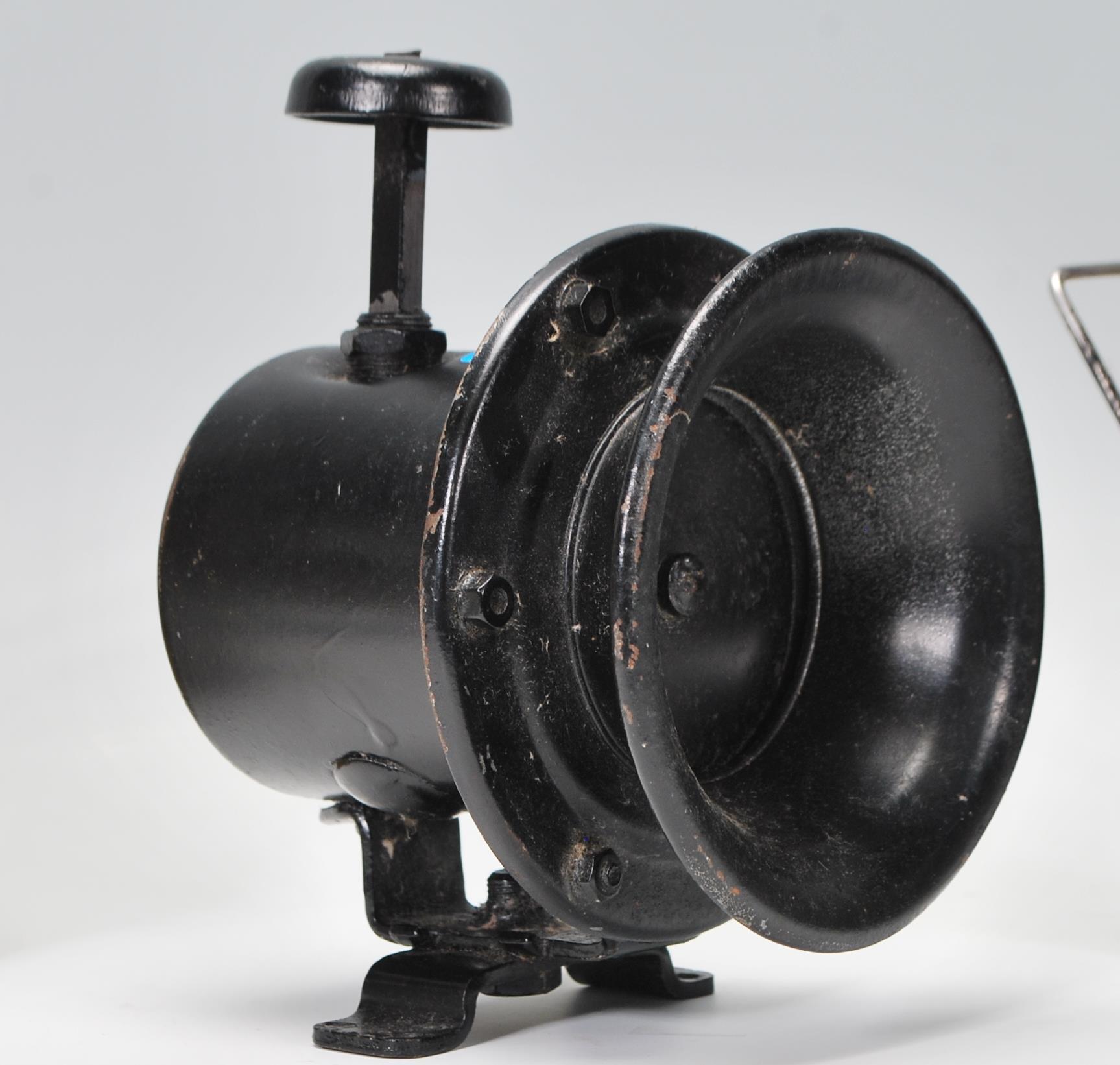 A vintage early 20th century police siren horn together with a a white