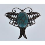 A stamped 925 silver brooch in the form of a stylised butterfly set with a oval turquoise