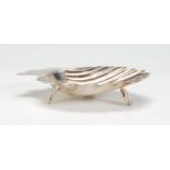 A 19th Century Walker and Hall silver hallmarked dish in the form of a scallop shell raised on three