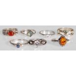 A collection of stamped 925 silver rings to include an amber cabochon ring, a white stone ring