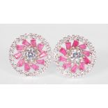 A pair of ladies silver stud earrings of round form set with patterned pink stones and CZ's.