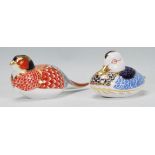 A Royal Crown Derby porcelain figurine of a pheasant together with another of a duck, both in seated
