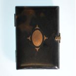 A 19th century Victorian tortoiseshell and gold cigarette case. The inset gold lozenge centre with