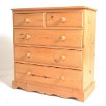 A contemporary pine chest of drawers being raised on a plinth base with two short over three deep
