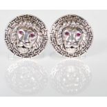 A pair of gentleman's silver cufflinks of round form with lions masks set with red eyes and greek