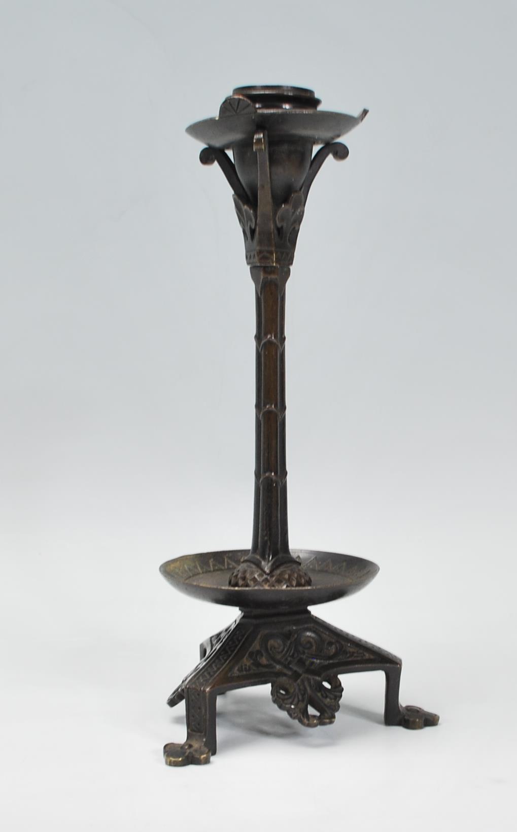 A late 19th / early 20th Century Arts and Crafts case bronzed candlestick raised on a tripod base - Image 4 of 7