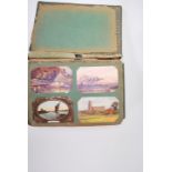 A large early 20th Century Edwardian postcard album including a wide selection of subjects including