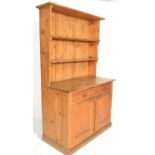 A late 19th / early 20th Century pine Welsh dresser, open fixed shelves over a configuration of