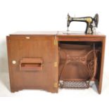 A 1930's Art Deco oak Singer Sewing machine cabinet / metamorphic table. The fold out door and hinge