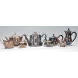 A collection of silver plated items to include a teapot, sugar bowl and creamer, pewter teapot,