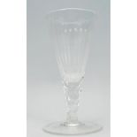 A Georgian wine glass of tapering form raised on a round footed base, the stem cut with hexagonal