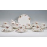 A mid 20th Century Royal Doulton tea service having floral sprays on white ground with gilt rims.