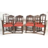 A set of 8 Ercol gothic revival early 20th century dining chairs. Raised on squared legs united by