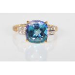 A 9ct gold hallmarked Neptune topaz and diamond dress ring, diamond chips to the shoulder flanking a