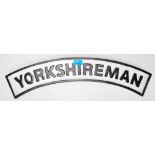A 20th Century cast iron wall sign of arched form having raised titling reading ' Yorkshireman ' and