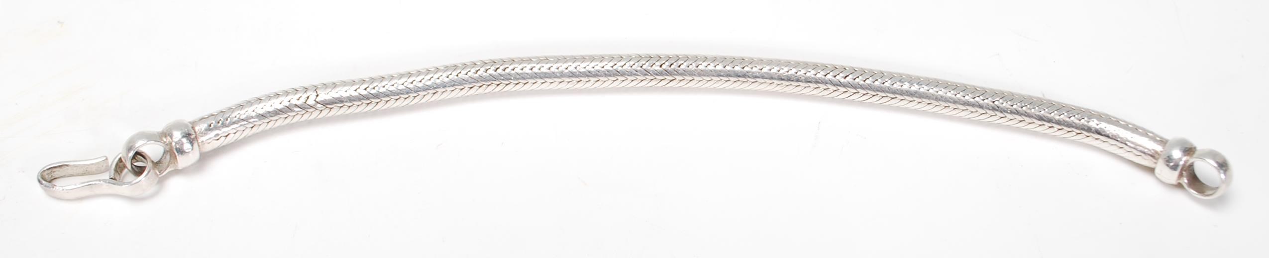 A stamped 925 large snake chain bracelet having a hook and eye clasp. Weight 64.3g. Measures 9