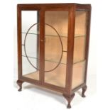 A 1930's Art Deco mahogany china display cabinet. Twin glass doors with embellished round fret