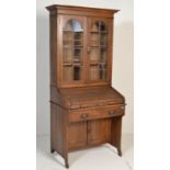 An early 20th century Arts and Crafts ' The Lebus Desk ' oak tambour roll top bureau bookcase,