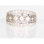 A hallmarked 14ct gold ladies dress ring set with three rows of CZ's with pierced decoration.