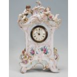 A 19th Century German porcelain cased mantel clock in the manor of Meissen. The clock of