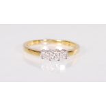 A stamped 18ct gold ladies ring set with three graduating square cut diamonds. Weight 2.2g. Size M.