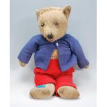 A vintage early 20th Century large jointed mohair Teddy Bear, the bear dressed in knitted woollen