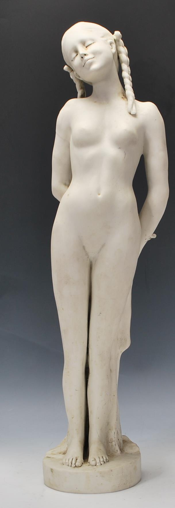 A 20th Century blanc de chine ceramic bisque standing figurine depicting a nude woman having plaited