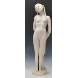 A 20th Century blanc de chine ceramic bisque standing figurine depicting a nude woman having plaited
