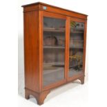 A 19th Century Victorian mahogany library bookcase cabinet having twin full length glazed panel