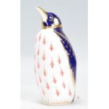 A Royal Crown Derby porcelain figurine of a penguin complete with the stopper and stamped with