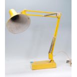 A retro 20th Century Italian Industrial anglepoise desk lamp in a yellow colourway having a