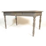 An early 20th century shabby chic country pine scrub top kitchen dining table. Raised on turned legs